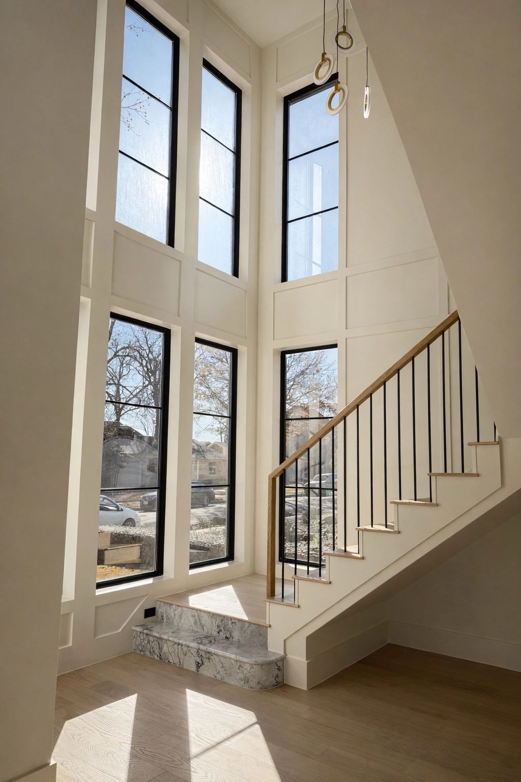 Staircase with tall windows — Select Custom Home